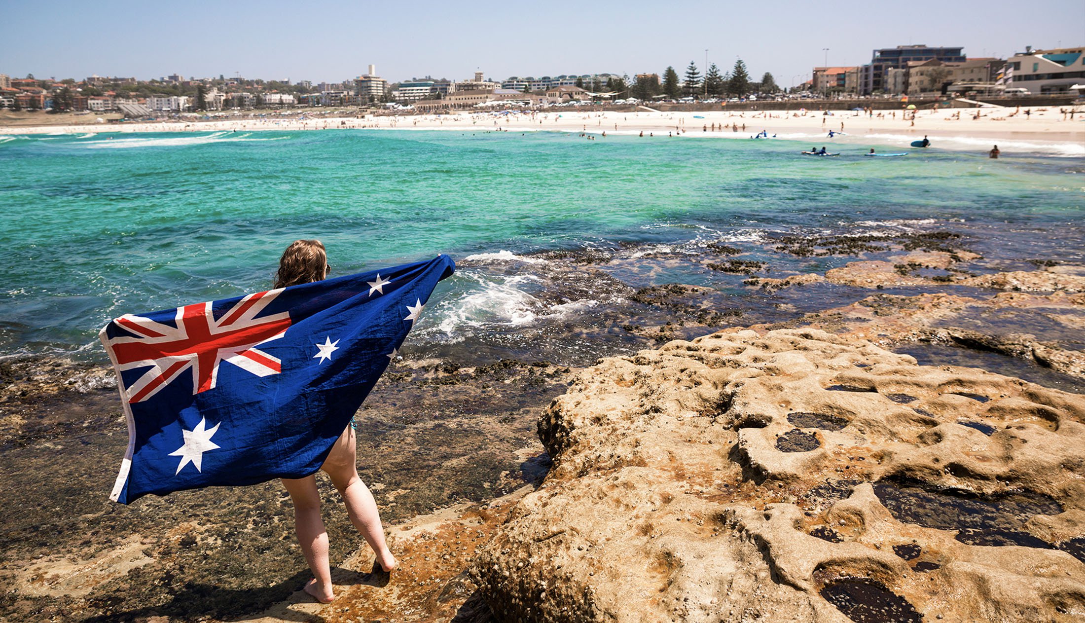 Intro Travel Oz Intro Group Tours Girl With Australia Flag In Bondi Beach